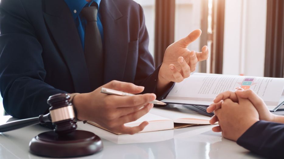 a lawyer speaking with a client