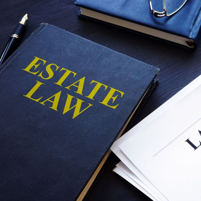 A book on estate law with some paperwork and a fountain pen