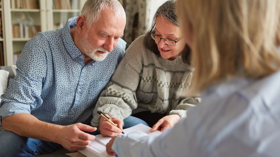 an older couple signing paperwork Featured Image (23).jpg