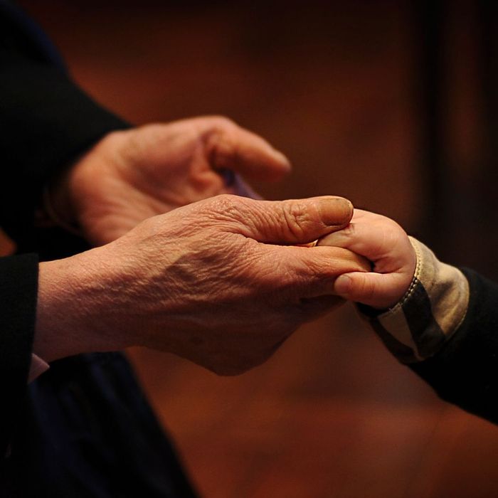 older hands with young toddler hand